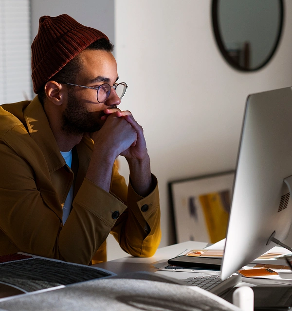 Person thinking at laptop